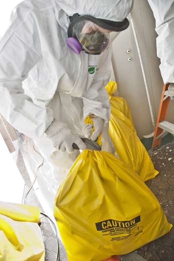 EnviroDoctors_Asbestos-Cleanup-worker-in-Bio-Hazard-Suit-with-Hazardous-Waste-Bag 2